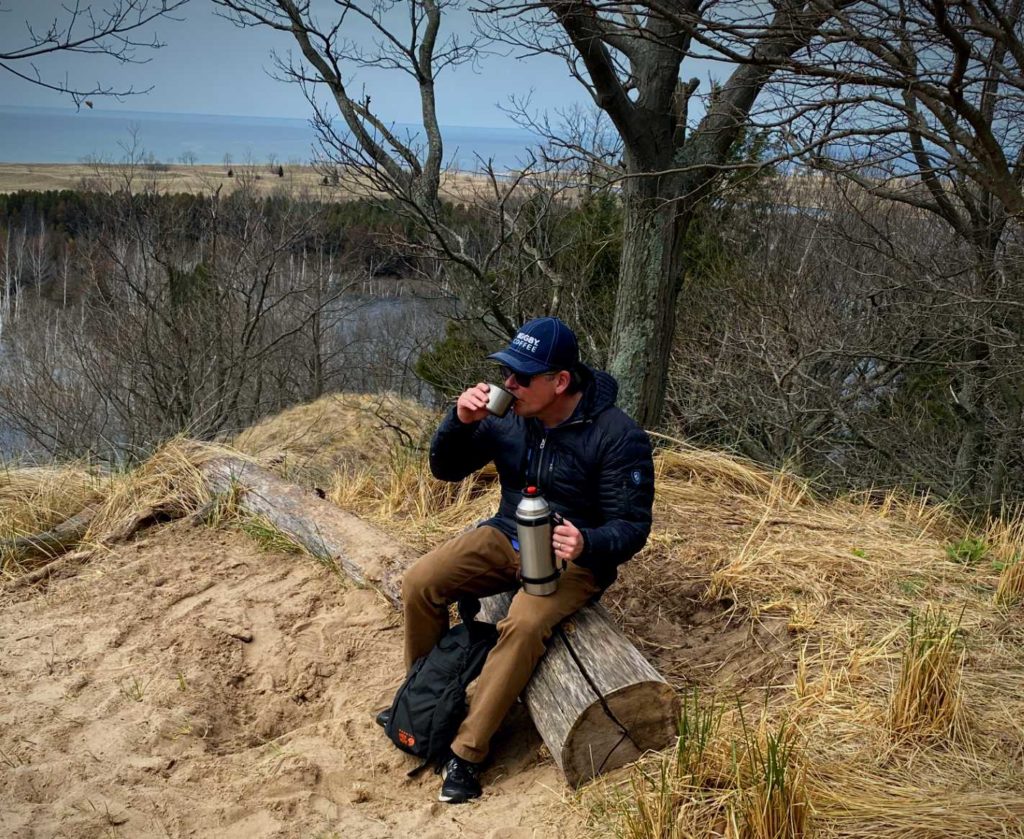 BIGGBY Coffee CEO Bob Fish drinking coffee on the trail